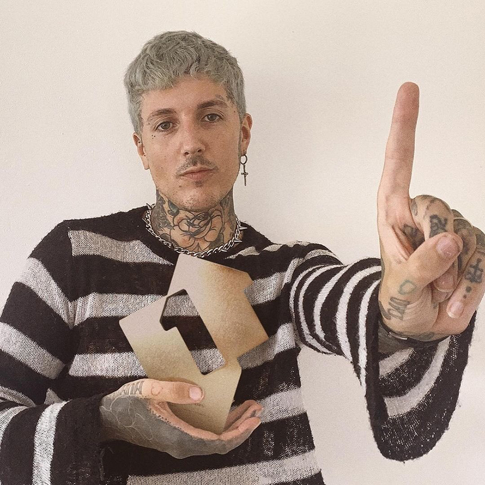 BMTH's Oli Sykes holding the band's OCC No.1 album trophy